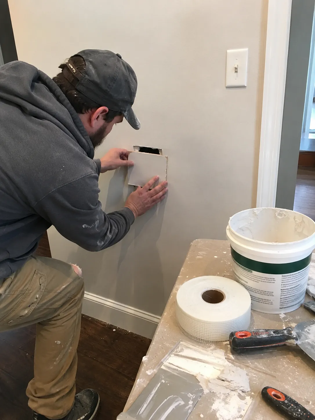 Worker patching a hole in an interior drywall wall in Las Vegas