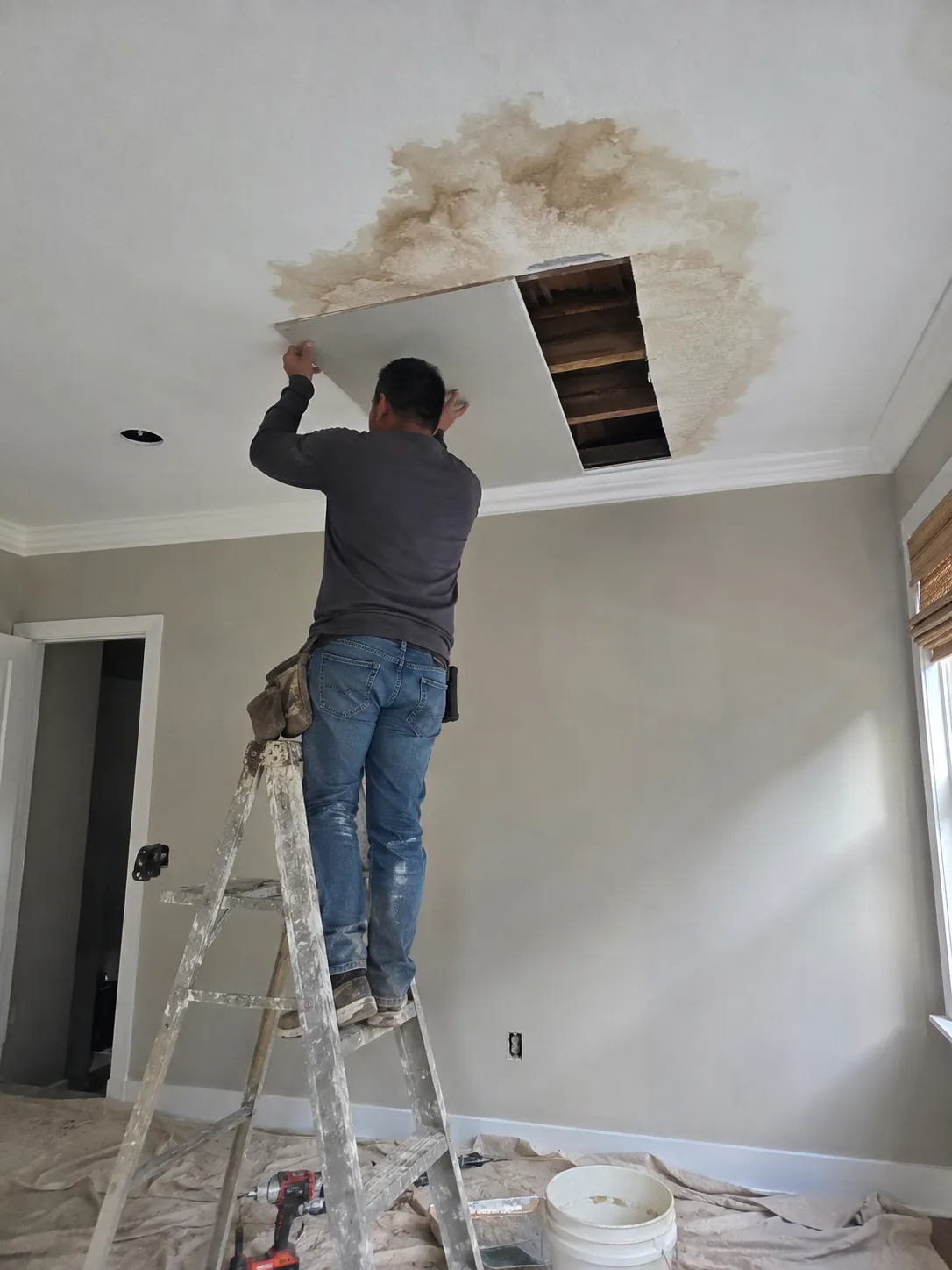 Repairing a water-damaged ceiling by fitting new drywall in Spring Valley